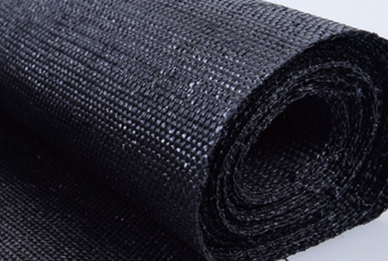 What material is the base fabric of artificial turf usually made of?